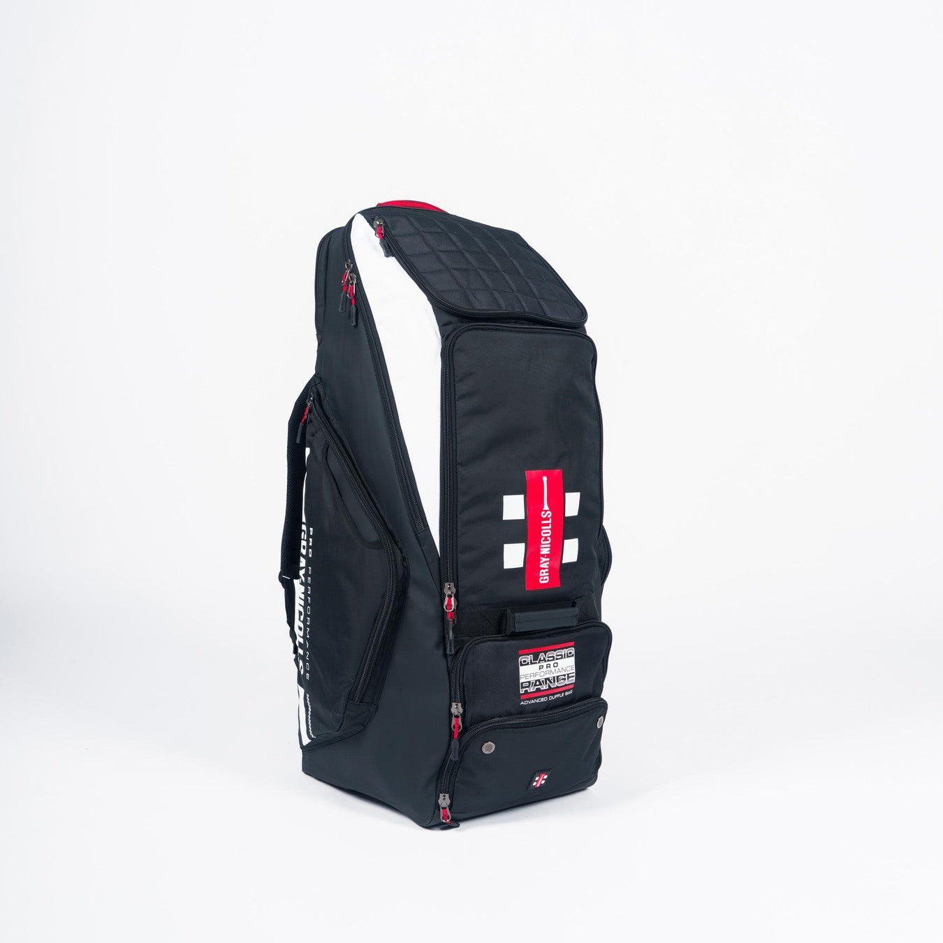 The Gray Nicolls Pro Performance Duffle 2026 is a tall black cricket duffle bag with white and red accents, zippered compartments, a quilted top, and a red handle. Bold white and red stripes on the front add a professional touch.