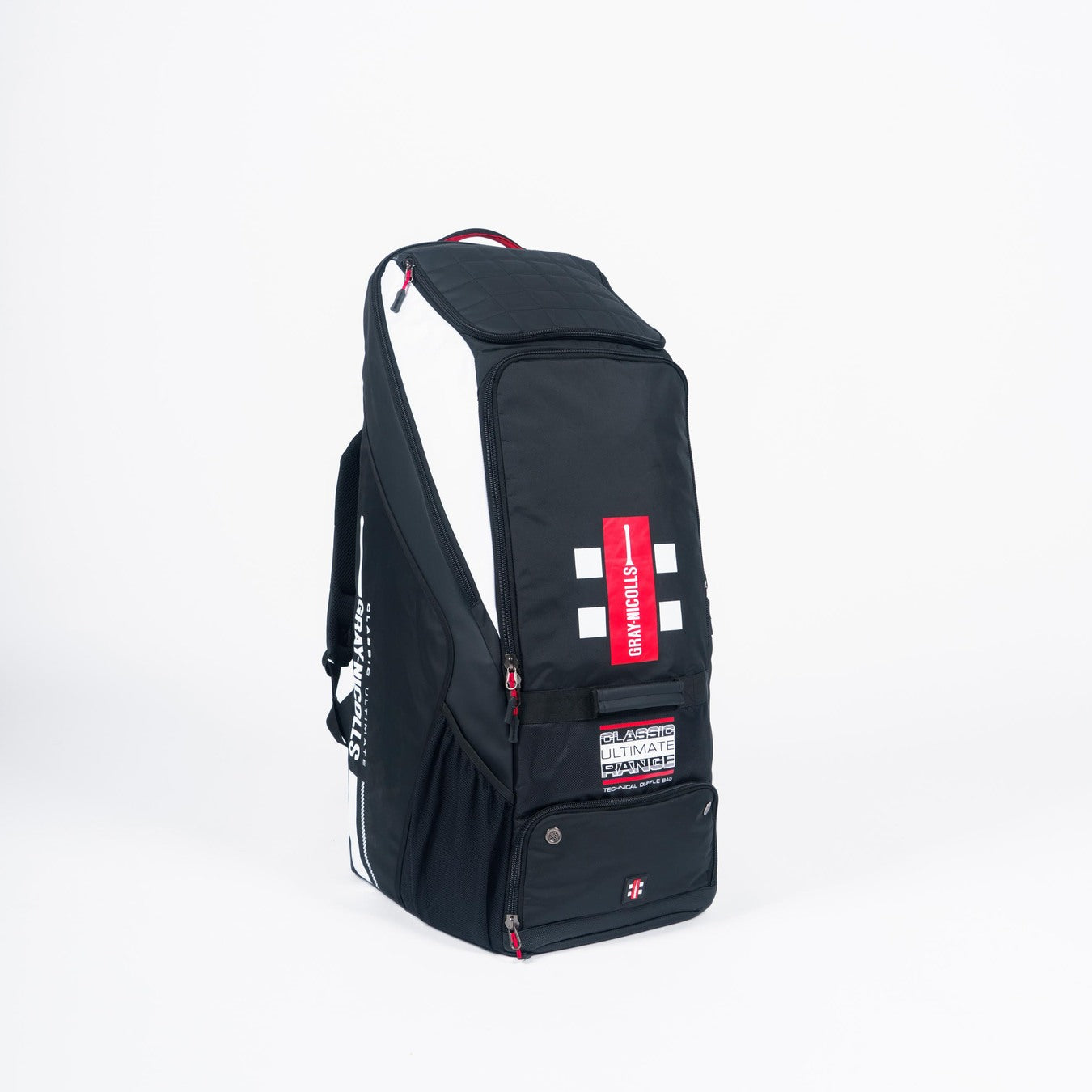 The Gray Nicolls Classic Ultimate Duffle 2026 is a black and white cricket kit bag with red accents, text labels, zippers, compartments, and a side pocket for storage. The stylish Gray Nicolls duffle stands upright on a white background.