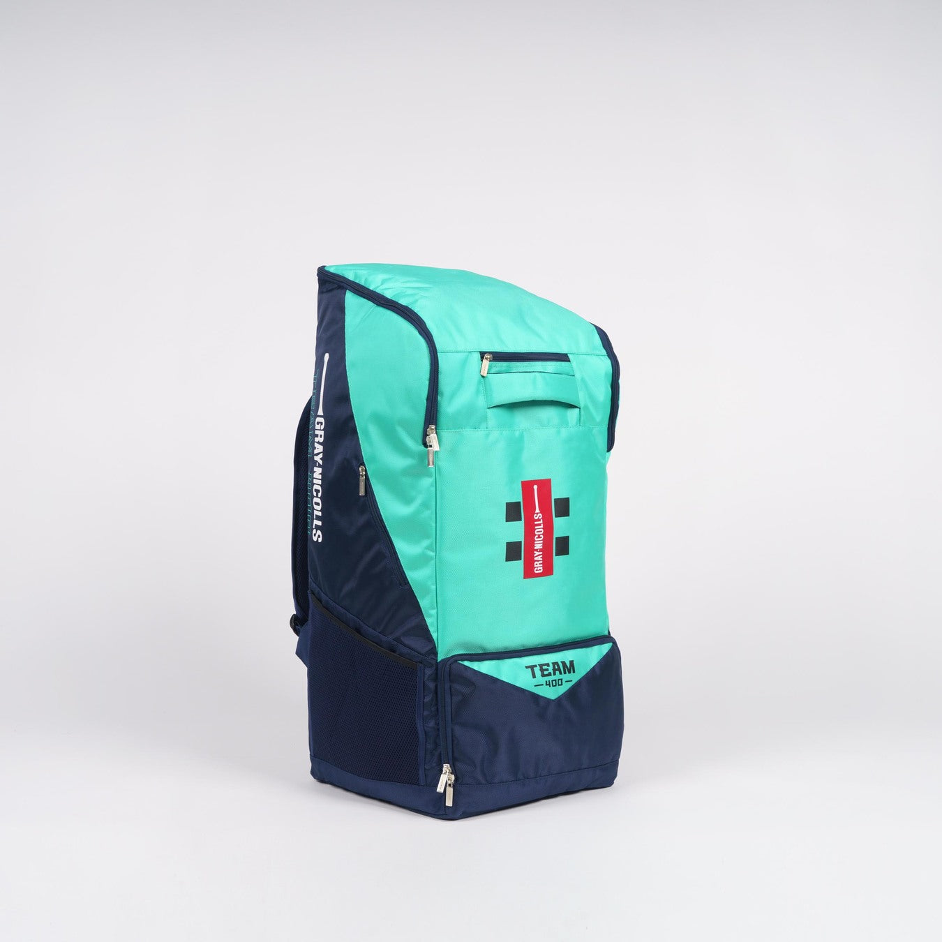 The Gray Nicolls Team 400 Duffle by Gray Nicolls is a navy and aqua sports backpack featuring zippered compartments, mesh side pocket, internal bat storage, and a red name tag on the front, standing upright on a plain white background.