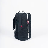The Gray Nicolls Players Academy Duffle 2026 in black features a top handle, red zipper pulls, white stripes, and a red-and-white logo—ideal as a small or junior duffle for stylish gear storage on a plain white background.