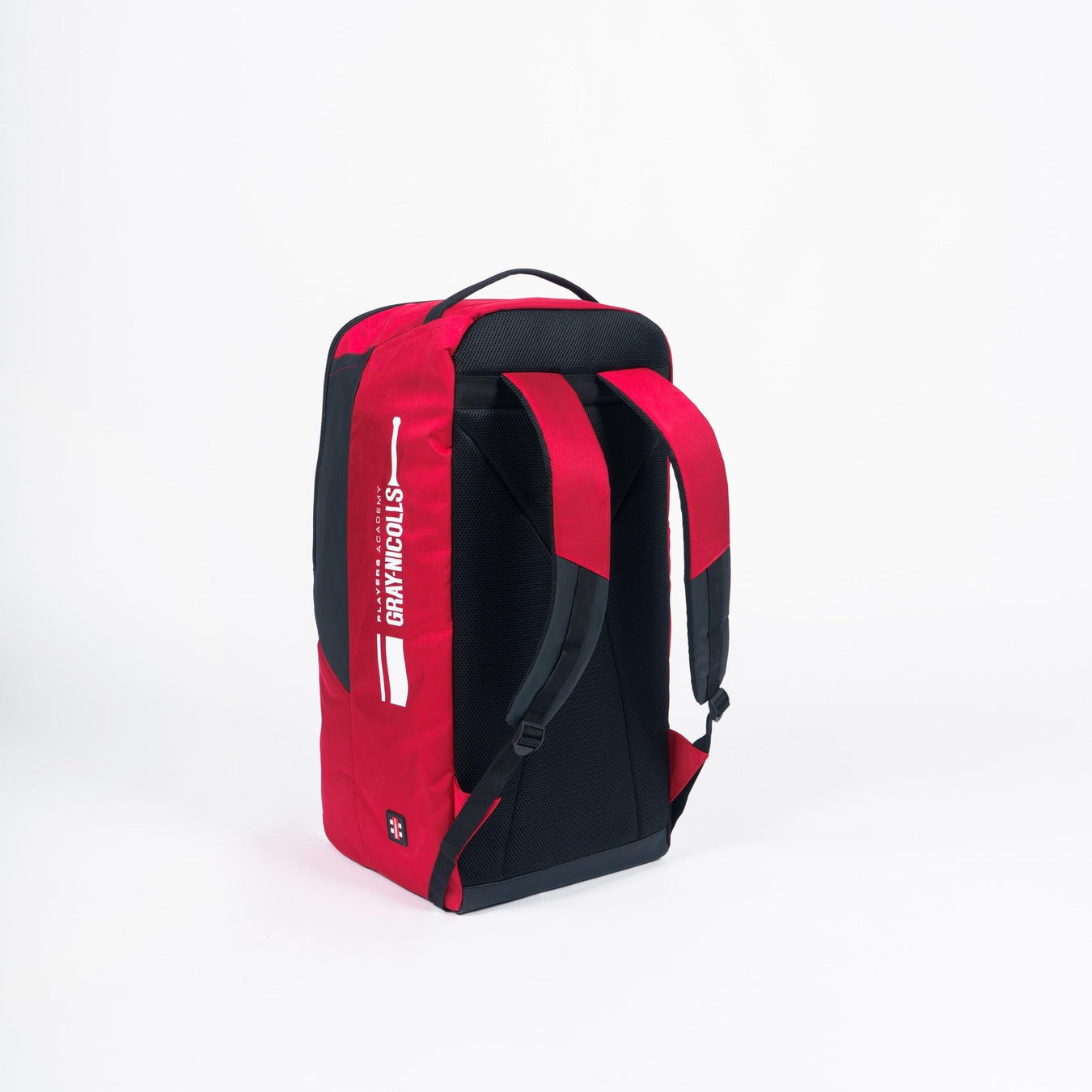 The Gray Nicolls Players Academy Duffle 2026 is a small red and black cricket bag with the brand logo in white, featuring padded shoulder straps and a top handle for easy carrying. Shown upright on a plain white background.