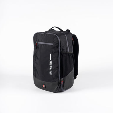 The Gray Nicolls Team 1.1 Rucksack is a black and gray sports backpack with multiple zippered compartments, a mesh side pocket, and "Gray-Nicolls" printed vertically on the front, shown against a white background.