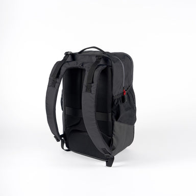 A black Gray Nicolls Team 1.1 Rucksack stands upright on a white background, showing the padded shoulder straps, mesh backing, and top handle—ideal as a cricket backpack by Gray Nicolls.