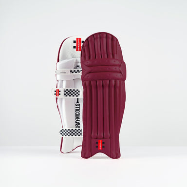 The Gray Nicolls Classic Prestige Batting Pads 2026 stand upright against a plain background in maroon, featuring padded straps, multilayer protection, and the Gray Nicolls logo at the top.