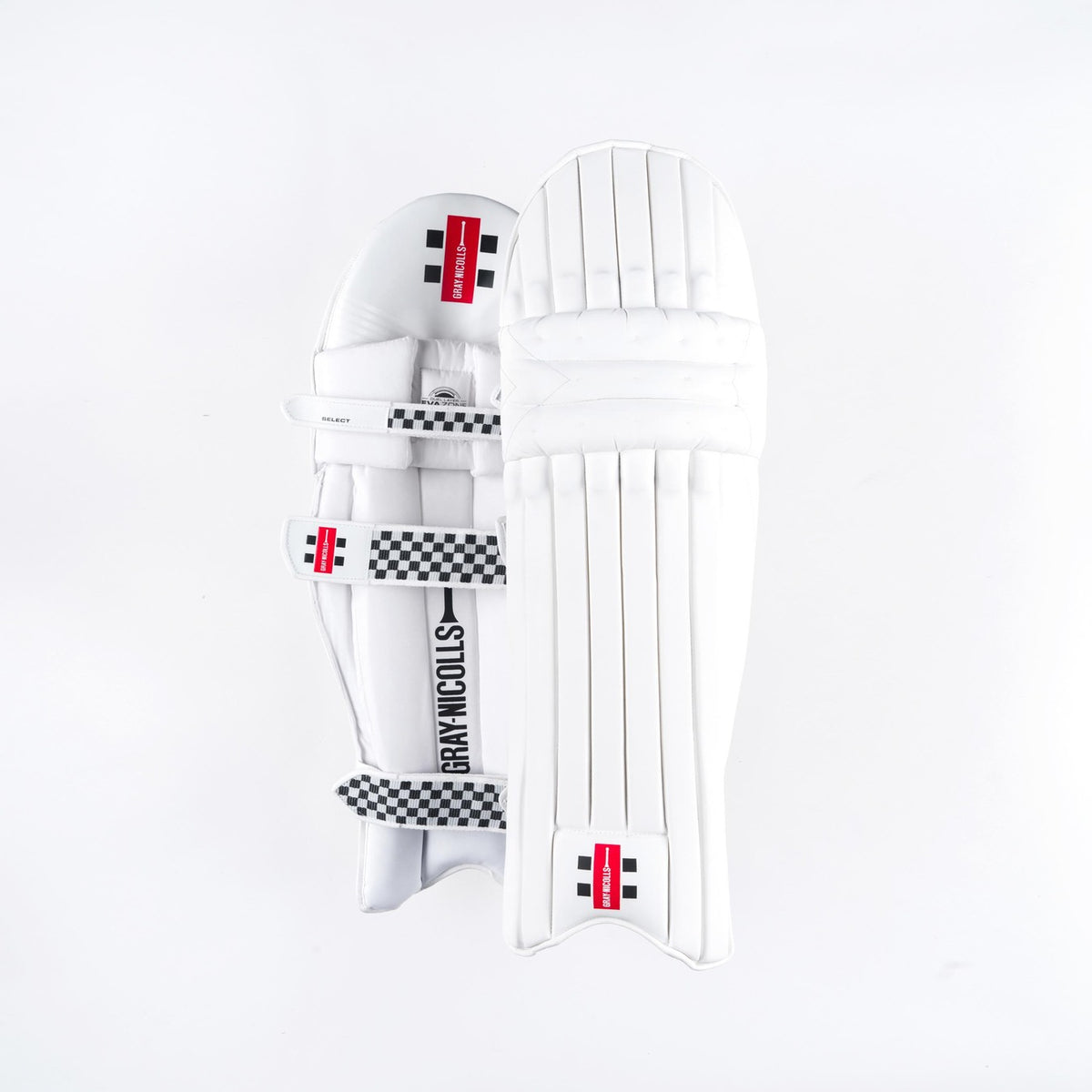 Two Gray Nicolls Classic Select Batting Pads 2026 in white are shown: one displays the front with vertical padding, while the other shows the back with straps and a checkered design, both featuring classic black and red branding.