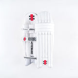 Gray Nicolls Classic Academy Batting Pads 2026: Junior pads with a lightweight PU front, black checkered details, secure straps, and red branding labels by Gray Nicolls, shown on a plain white background.