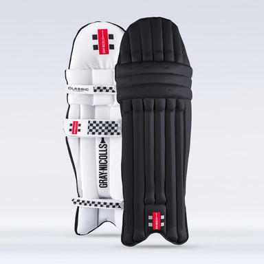 The Gray Nicolls Academy Coloured Batting Pads - GEM in black stand upright side by side, showing branding and straps—a stylish option for women’s cricket gear. The background is plain light grey.