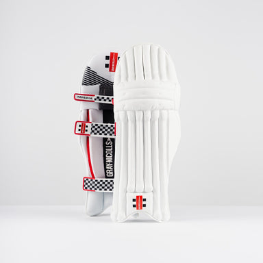 A pair of Gray Nicolls Imperia 1.0 Batting Pads 2026 in white with red and black checkered straps, offering high-impact resistance and superior cricket protection, featuring the iconic Gray Nicolls branding, upright against a plain white background.