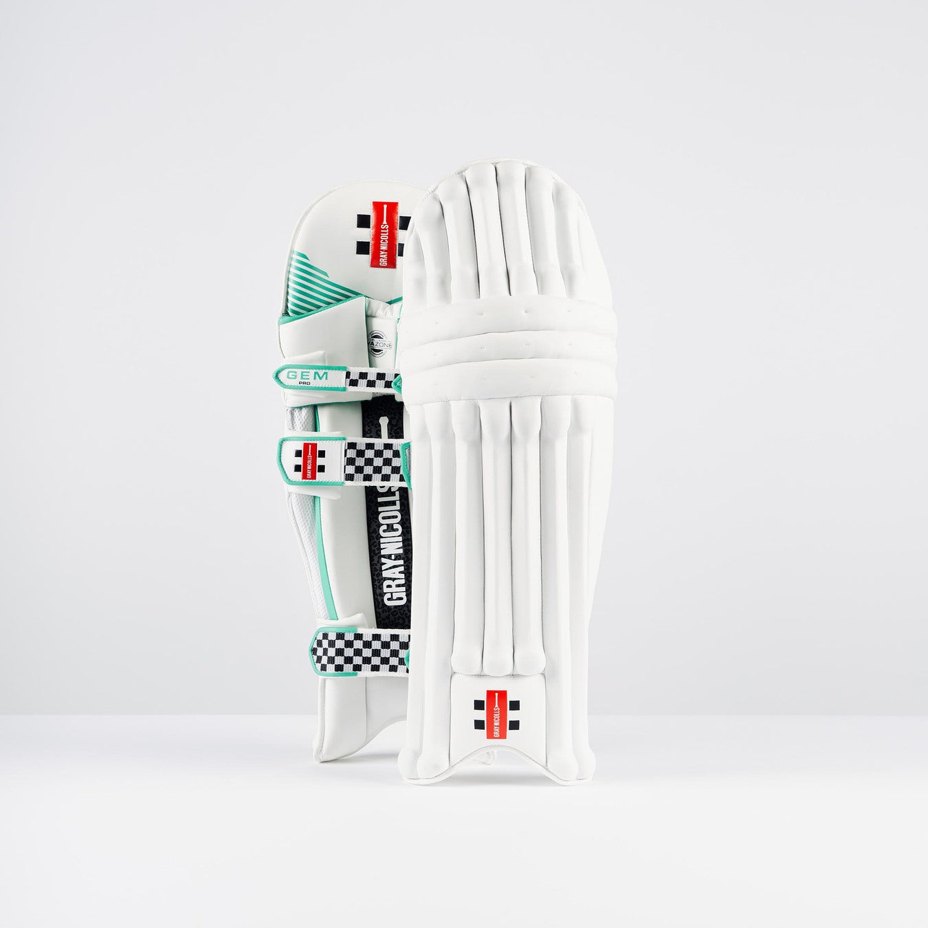 A pair of Gray Nicolls GEM 3.0 Pro Batting Pads 2026, featuring teal accents and black-and-white checkered straps, are shown upright on a white background—one displaying the front and the other showing the inner side.