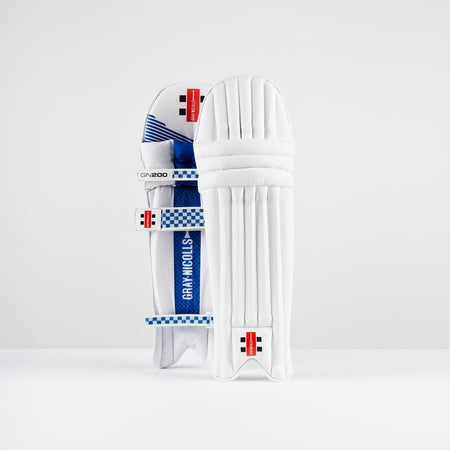 The Gray Nicolls GN200X Batting Pads 2026, featuring blue and black accents, straps, and branded details, are designed for cricket protection and stand upright against a plain white background.