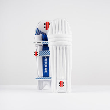 The Gray Nicolls GN200X Batting Pads 2026, featuring blue and black accents, straps, and branded details, are designed for cricket protection and stand upright against a plain white background.
