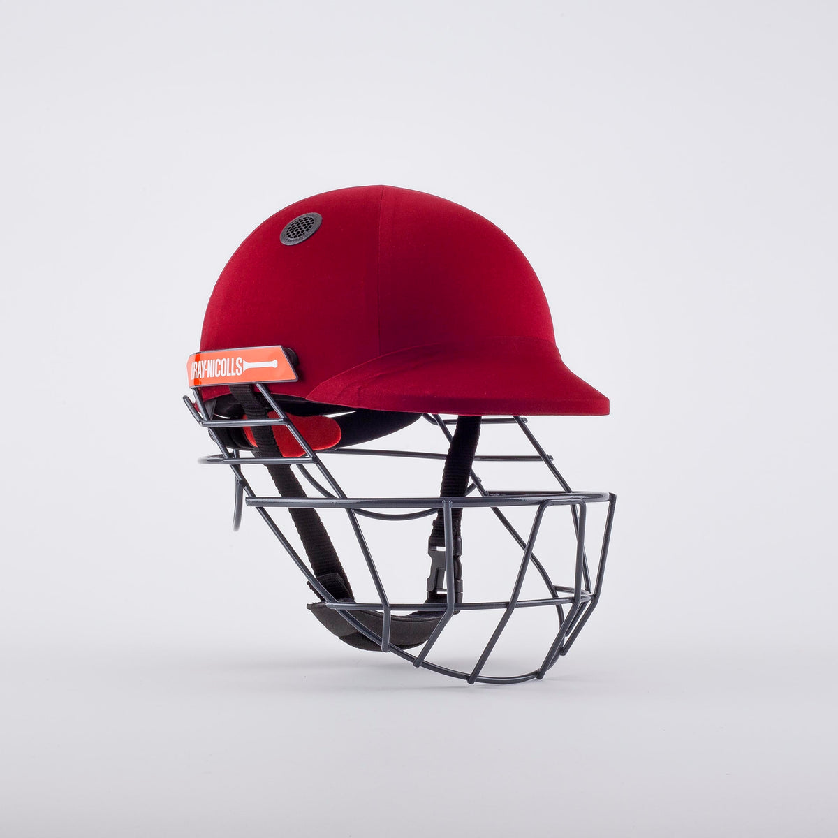 A maroon Gray Nicolls Atomic 360 Helmet with a protective metal faceguard is displayed against a white background. This cricket helmet features black interior padding, a side vent, and offers essential protection during play.