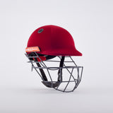 A maroon Gray Nicolls Atomic 360 Helmet with a protective metal faceguard is displayed against a white background. This cricket helmet features black interior padding, a side vent, and offers essential protection during play.