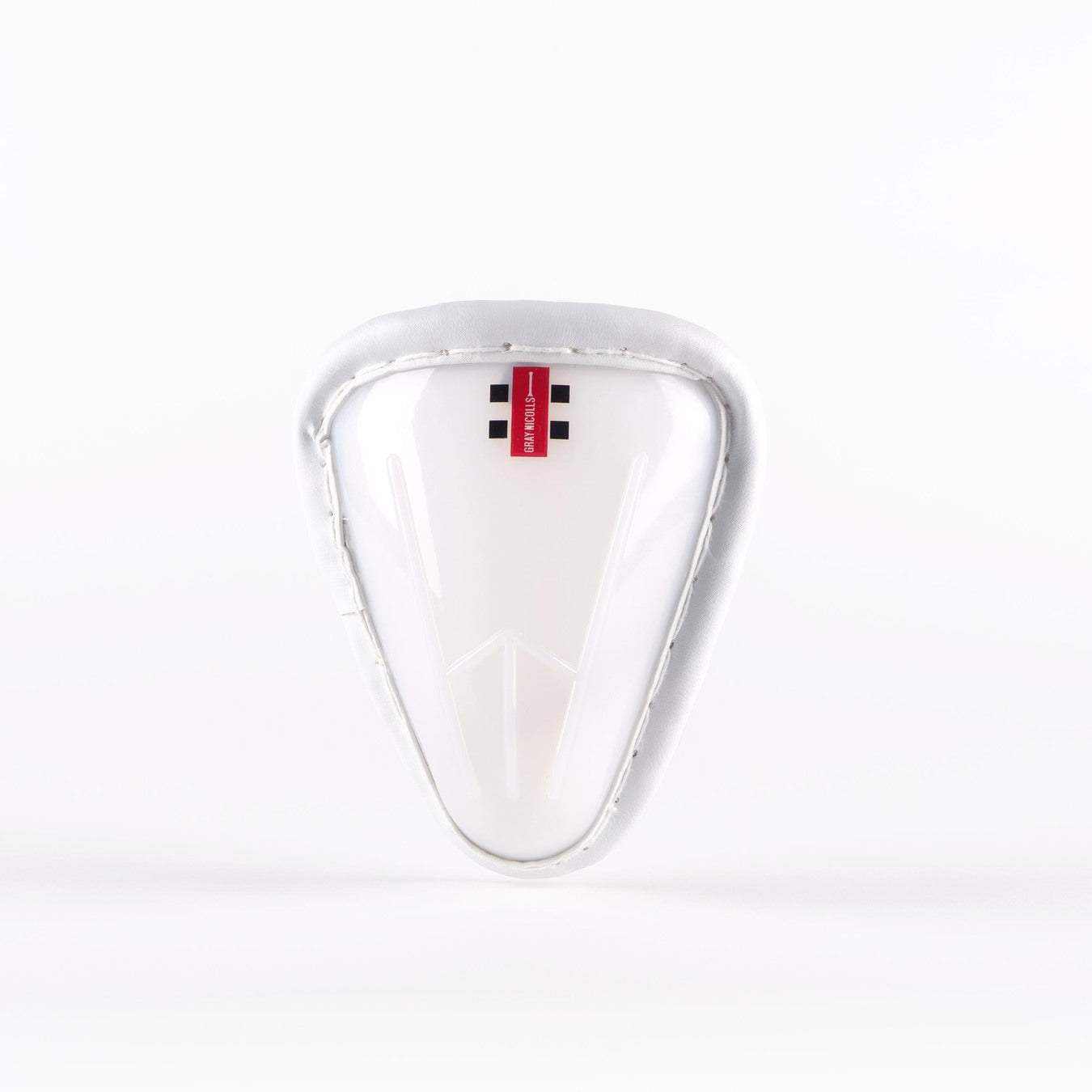 A Gray Nicolls Male Abdo Guard, featuring a white athletic protective cup with a padded rim and a small red Gray Nicolls label at the top, is displayed against a plain white background.