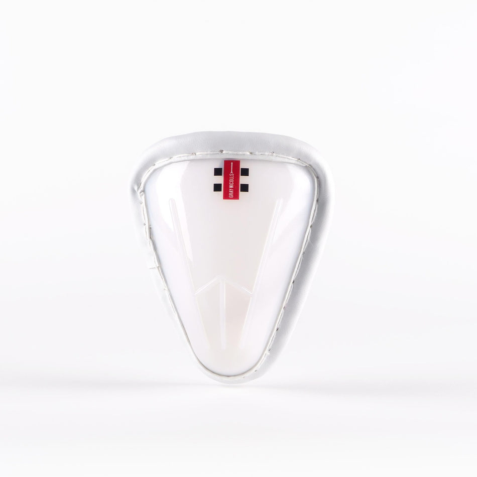 A Gray Nicolls Male Abdo Guard, featuring a white athletic protective cup with a padded rim and a small red Gray Nicolls label at the top, is displayed against a plain white background.