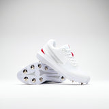 The Gray Nicolls Revo Pro 2.0 Cricket Spikes by Gray Nicolls feature white uppers with silver and red accents, a Maxcool Duo upper, Energise midsole, and metal studs. One shoe stands upright while the other shows the studded sole.