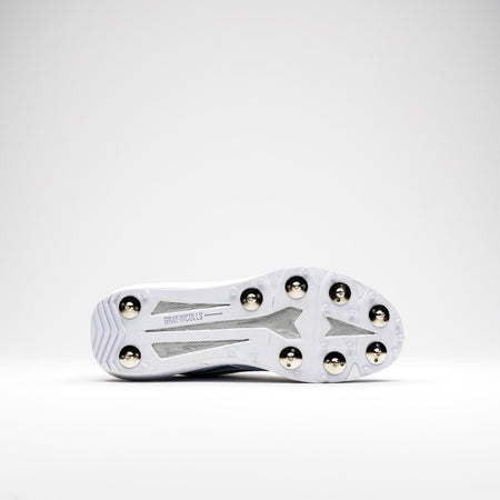 The Gray Nicolls Revo Pro 2.0 Cricket Spikes is a white shoe with six metal spikes, grey mesh accents, and visible Gray Nicolls branding on the sole. It features Energise midsole technology for enhanced performance.
