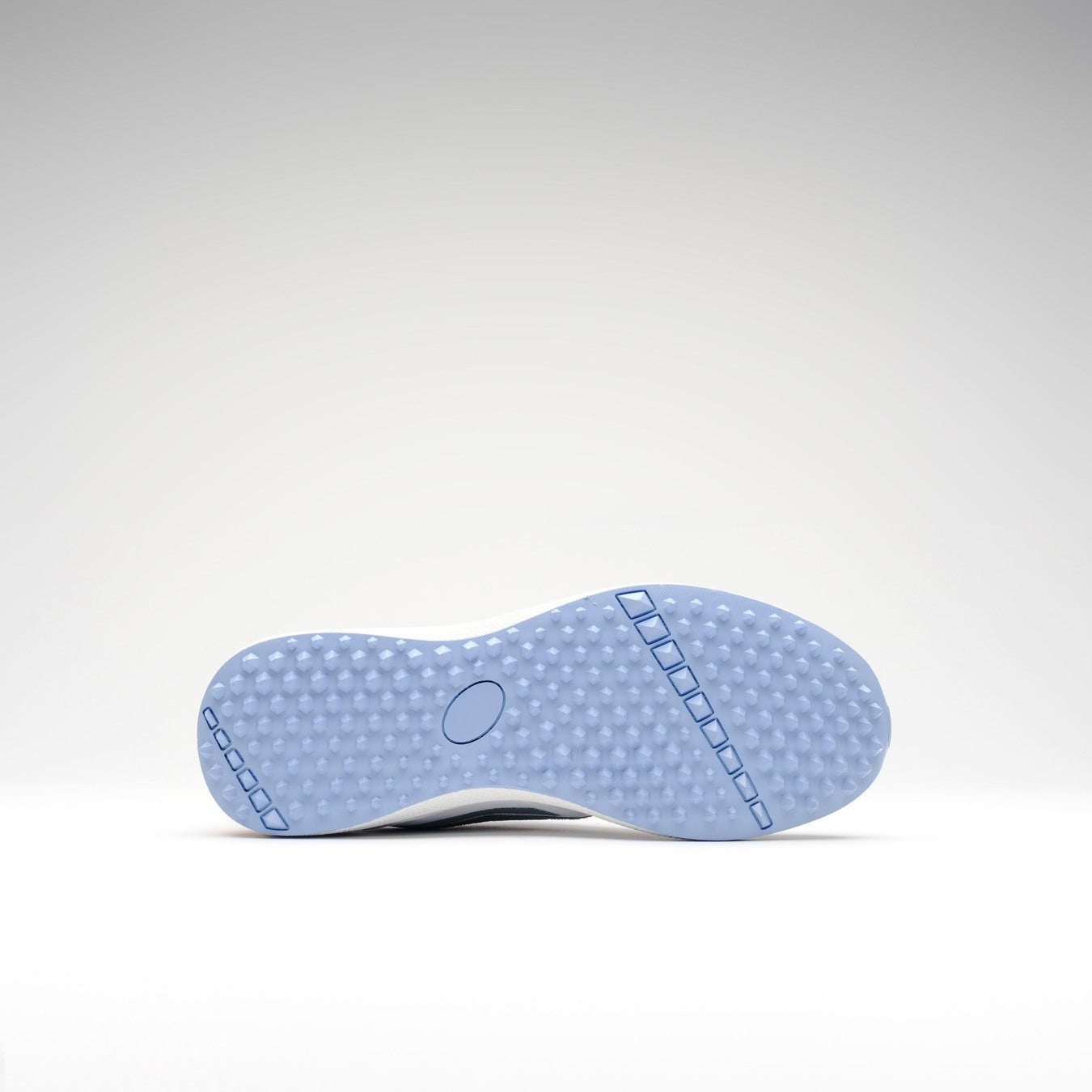 The image displays the light blue sole of the Gray Nicolls Velocity 5.5 Narrow Rubber Soled Cricket Shoe for women, featuring a textured dotted pattern and straight grooves for grip, photographed from below against a plain white background.