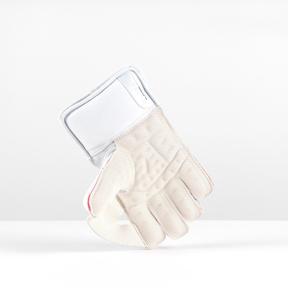 The Gray Nicolls Classic Players Edition WK Gloves 2026 are premium white leather cricket gloves with octopus grip padding on the fingers and palm, and a wide wrist strap, shown standing upright on their cuffs against a plain background.