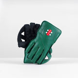 The Gray Nicolls Classic Players WK Gloves 2026, featuring green color, octopus rubber grip, black palms, and red logo detailing, are displayed upright against a plain white background.