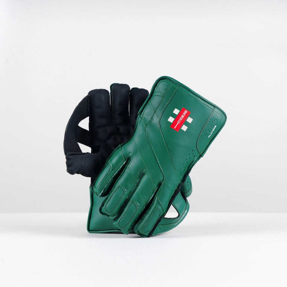 The Gray Nicolls Classic Players WK Gloves 2026, featuring green color, octopus rubber grip, black palms, and red logo detailing, are displayed upright against a plain white background.