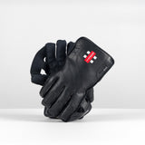 The Gray Nicolls Classic Elite WK Glove 2026 by Gray Nicolls is displayed upright on a white surface against a plain, light background, showing its classic design and superior comfort.