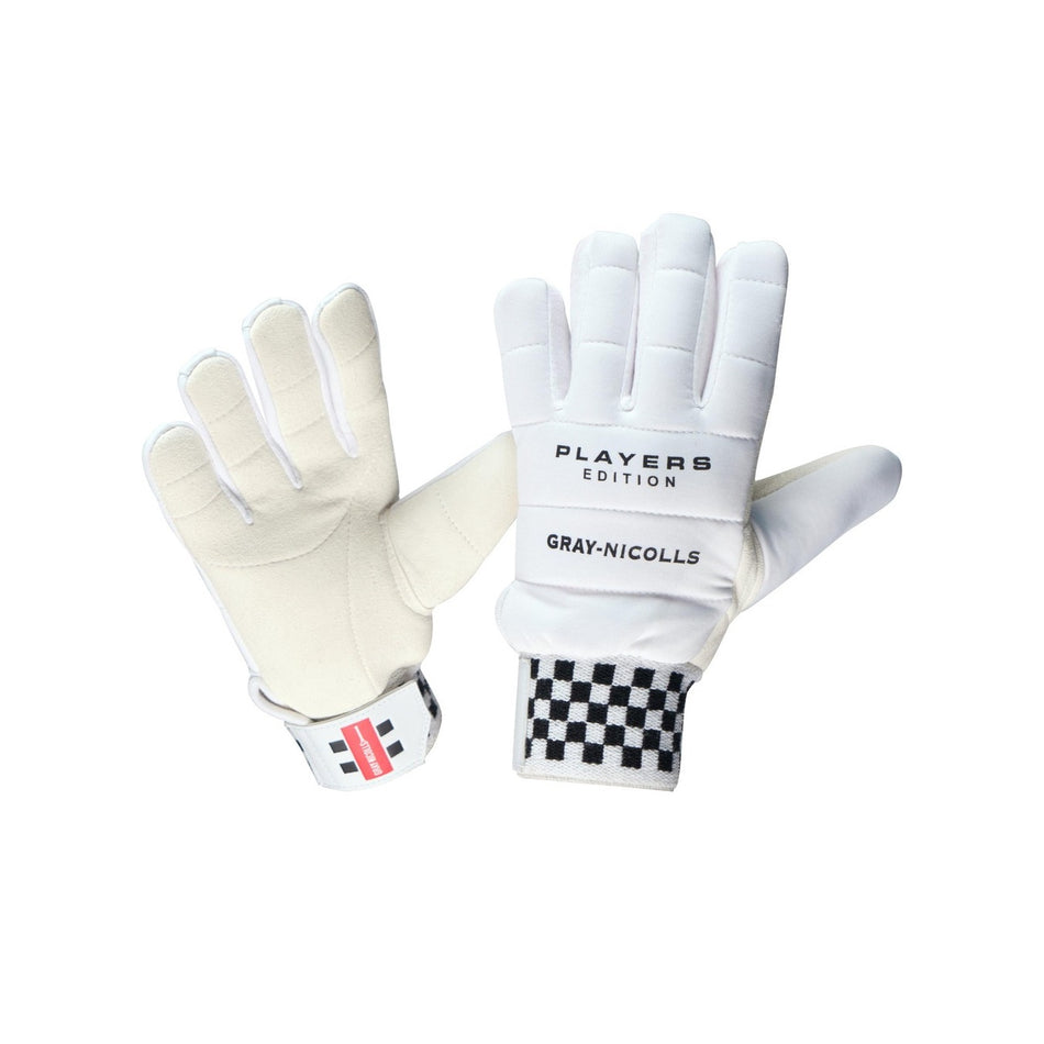 A pair of Gray Nicolls Players Edition XDX WK Inners gloves; one shows the leather palm with brand text, the other displays the padded back, checkered sweatband cuff, and red-striped Velcro strap.