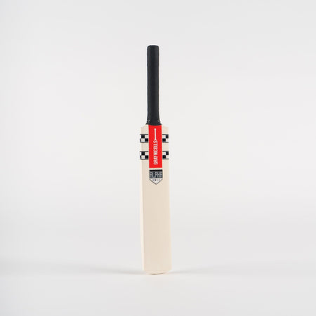 The Gray Nicolls Miniature Cricket Bat features a black handle and a red and white Gray Nicolls label near the top, shown standing upright against a plain white background.