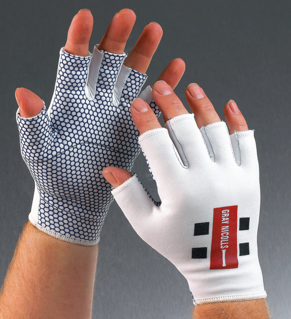 Two hands wear Gray Nicolls Catching Gloves. The palms have a black and white hexagonal grip pattern, while the backs are white with a red and black Gray Nicolls logo. Background is gray.