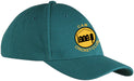 A teal Martin Berrill Sports Custom Baseball Cap with yellow badge showing a black building and tree, plus "CAM CRICKET CLUB" text. Order Custom Baseball Caps with no minimum quantity.