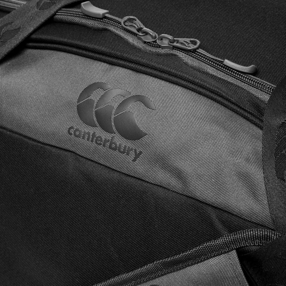 Close-up of the black Canterbury Classic Holdall Bag with the CCC logo and canterbury text below a zip pocket. Made by Canterbury, it features durable Vaposhield fabric with visible zipper details for extra toughness.