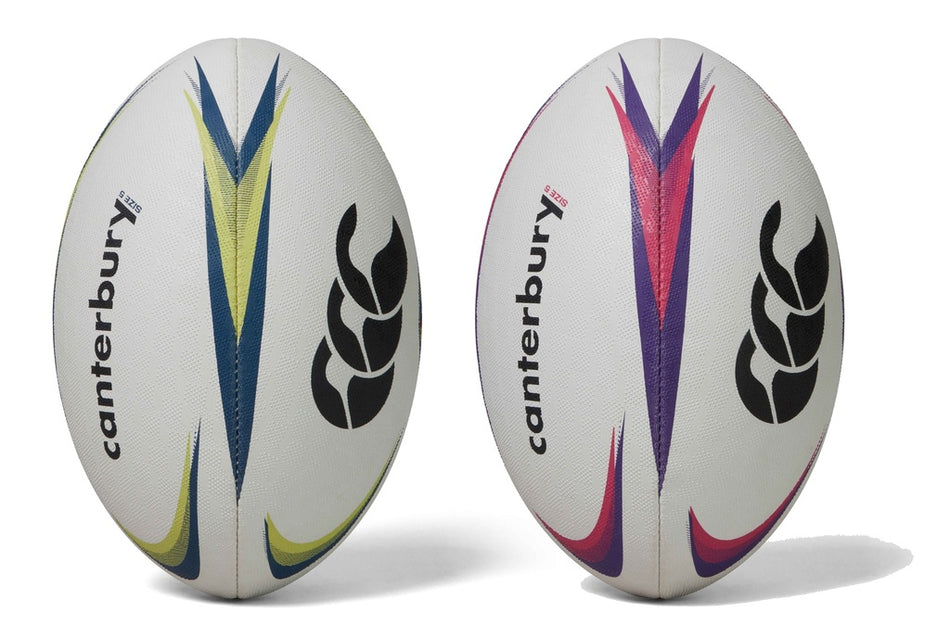Two Canterbury Mentre Rugby Balls stand upright side by side on a white background. One features blue and yellow accents, the other purple and pink, both with black Canterbury logos. Designed for enhanced grip and durability in every training session.