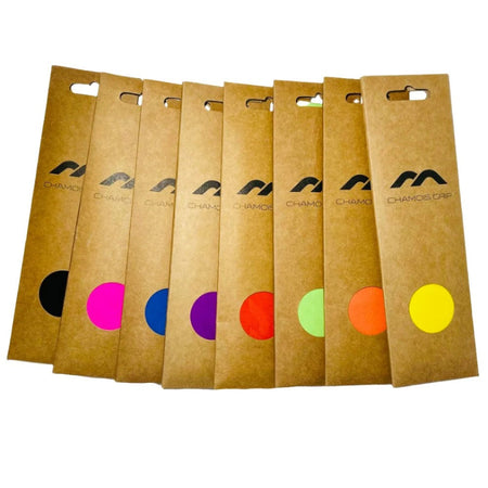Ten brown Mercian Chamois Hockey Grip packages are arranged in a row, each with a different colored circle and the Mercian logo—ideal for any chamois hockey grip or hockey stick grip enthusiast.