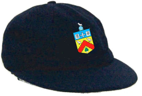 The Custom Traditional Cricket Caps by Martin Berrill Sports feature dark fabric and custom embroidery—a crest with a blue cross, white bird, and red chevron—ideal as commemorative caps.