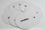 A stack of white Flat Disc Markers by Samba Sports, each printed with the brand name in black, arranged overlapping on a white surface. These non-slip markers are perfect for training session positioning.