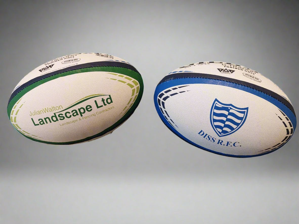 Two Custom Gilbert Match or Training Rugby Balls with Logos are shown—one with green accents for Julian Walton Landscape Ltd., the other with blue and the Diss R.F.C. logo—demonstrating how Gilbert's branded rugby balls suit any club or business.