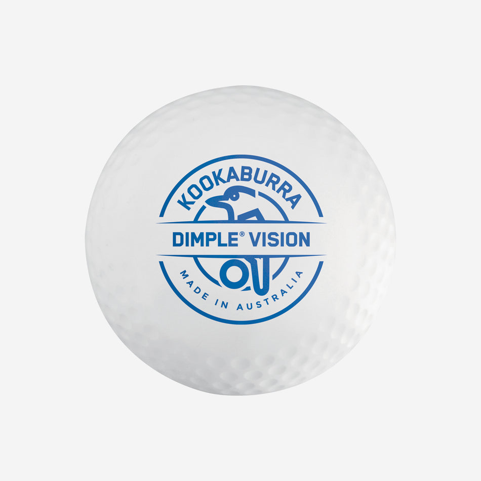The Kookaburra Dimple Vision Hockey Ball is a white ball featuring the blue Kookaburra logo with a bird outline, Made in Australia, and has a dimpled surface characteristic of the Dimple Vision range.