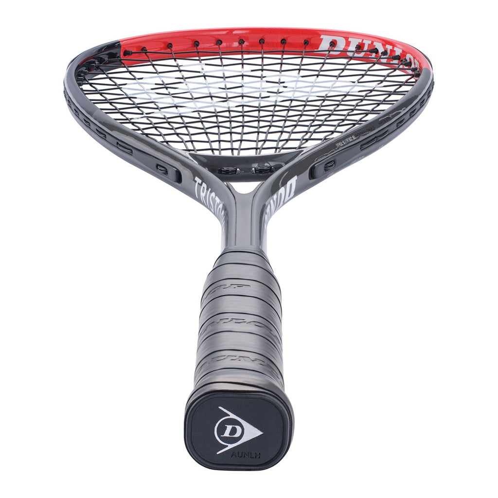 A close-up of the Dunlop Tristorm Lite TI Squash Racket shows its black aluminium frame with a red-edged head and wrapped grip, photographed from handle to strings.