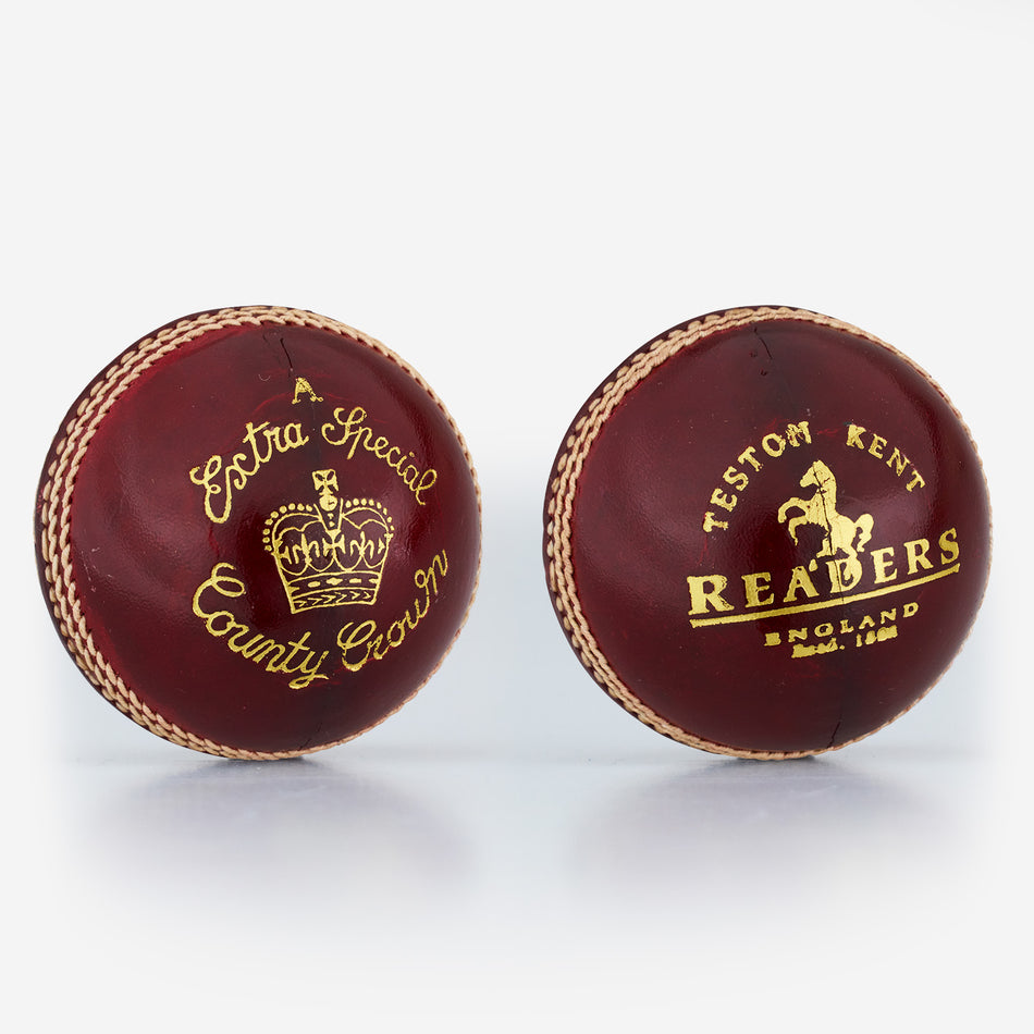 Two red Readers Extra Special A cricket balls, hand-stitched from alum-tanned leather with gold stitching and text—one reads "A Extra Special County Crown" with a crown, the other "Testom Kent Readers England.