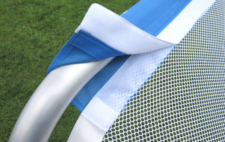 Close-up of a Samba Sports Samba 3v3 4ft x 2.5ft Aluminium Folding Football Goal, showing the white mesh net attached to a silver frame with blue and white straps on green grass.