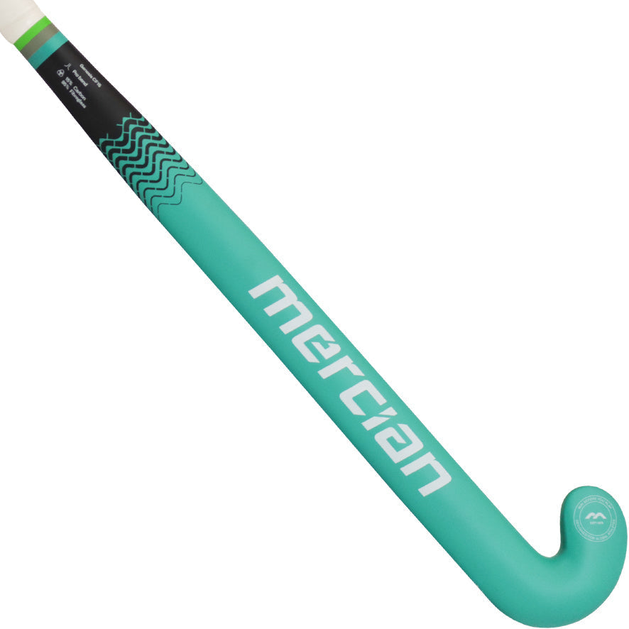A turquoise Mercian Indoor Genesis CF25i Low field hockey stick with a curved end, black grip, and white logo—designed for precision dragflicking—is shown against a plain white background.