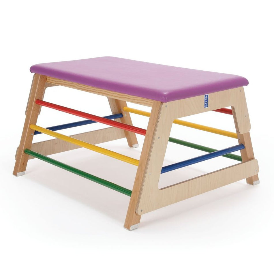 The Niels Larsen Activbar Box by Niels Larsen is a wooden junior bar box with a purple padded vinyl top and four coloured side bars—red, yellow, blue, and green—designed for children's play or exercise.