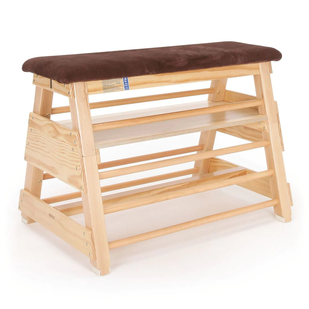 The Niels Larsen Vaulting Bar Box - Hide Top by Niels Larsen features three wooden steps, side rungs, and a cushioned natural hide top—ideal for gymnastics or physical education activities.