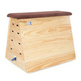 The Niels Larsen Traditional Vault Box - Hide Top features a padded brown natural hide top, interlocking corner blocks, and multiple side slots—ideal for gymnastics or PE. Optional castors available. Brand: Niels Larsen.