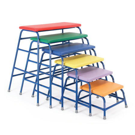 The Niels Larsen Agility Table set (SET 3) includes six colorful tables with blue frames and vinyl padded tops, stacked in ascending height like adjustable tables, all from the Niels Larsen brand.