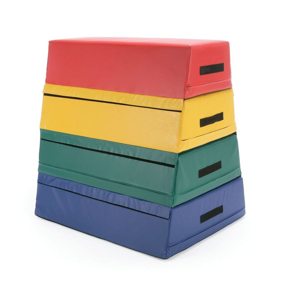 The Niels Larsen Activsoft 4 Section Vault Box by Niels Larsen features four stackable soft mats in red, yellow, green, and blue with side handles and an anti-slip base—ideal for gymnastics or physical activities.