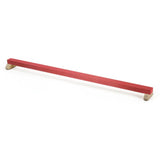 The Niels Larsen Junior Floor Beam, by Niels Larsen, is a red balance bar with rubber grips and wooden supports at each end, shown against a white background.