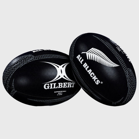 A Gilbert All Blacks Supporter Rugby Ball Size 5, featuring the GILBERT logo and silver fern, sits on a plain gray background—ideal for any New Zealand rugby fan's collection.