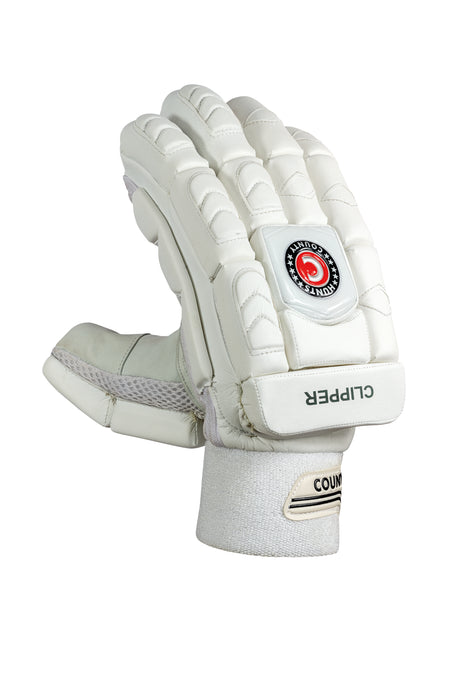The Hunts County Clipper Batting Gloves feature padded white fingers for protection, a velcro wrist strap, HCB branding, COUNTY and CLIPPER logos, a red circular emblem on the back, and a premium leather palm.