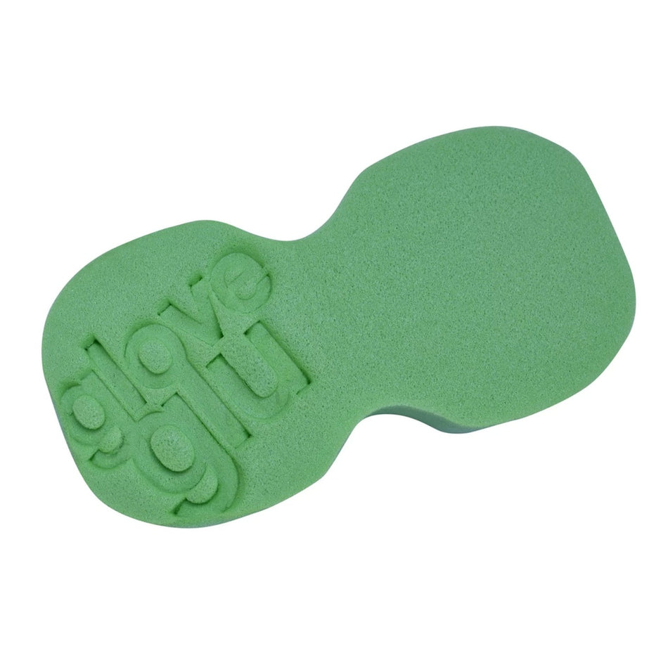 The GloveGlu Keep 'Em Clean Sponge by GloveGlu is a green micro cell sponge with "glove glu" embossed, featuring an ergonomic, irregular shape and two rounded sections for better grip and improved surface cleaning.